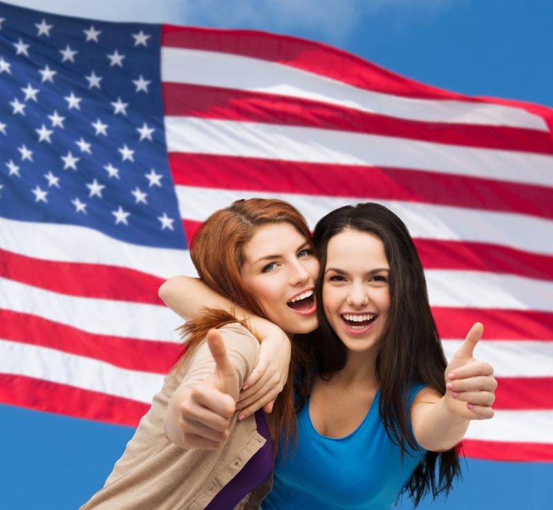 2 women in front of a flag