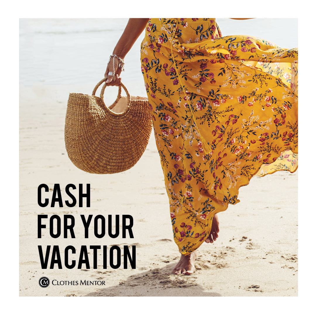 woman in dress with bag on beach